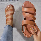 Flat sandals with open back and buckle decoration
