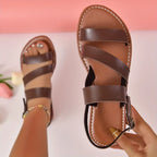 Flat sandals with open back and buckle decoration