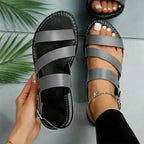 Flat sandals with open back and buckle decoration