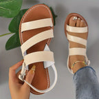 Flat sandals with open back and buckle decoration